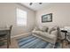 Bright bedroom featuring wood floors, a window, and a small sofa at 17459 Palmetto Pass Ln, Punta Gorda, FL 33982