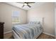 Bright bedroom featuring wood floors, one window, and a white headboard at 17459 Palmetto Pass Ln, Punta Gorda, FL 33982