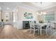 Inviting dining area featuring wood floors, a stylish chandelier, and a large window for natural light at 17459 Palmetto Pass Ln, Punta Gorda, FL 33982