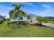Charming single-story home with lush landscaping, mature palm trees, and a well-maintained lawn in a tranquil setting at 17459 Palmetto Pass Ln, Punta Gorda, FL 33982