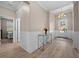 Inviting foyer featuring wood floors, decorative wainscoting, and a chandelier, creating a warm entrance to the home at 17459 Palmetto Pass Ln, Punta Gorda, FL 33982
