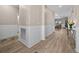 Bright hallway featuring wood floors and an open concept view of the house at 17459 Palmetto Pass Ln, Punta Gorda, FL 33982