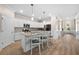 Bright kitchen features granite countertops, stainless steel appliances, white cabinetry, a center island, and breakfast bar at 17459 Palmetto Pass Ln, Punta Gorda, FL 33982