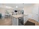 Bright open-concept kitchen with granite countertops, stainless steel appliances, white cabinets, and seamless flow to dining area at 17459 Palmetto Pass Ln, Punta Gorda, FL 33982