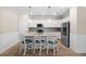 Bright kitchen features granite countertops, stainless steel appliances, white cabinetry, a center island, and breakfast bar at 17459 Palmetto Pass Ln, Punta Gorda, FL 33982