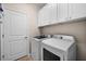 This laundry room features white cabinets and newer model washer and dryer at 17459 Palmetto Pass Ln, Punta Gorda, FL 33982