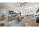 Open-concept living room with a large sectional sofa, decorative rug, and seamless flow to the kitchen and dining area at 17459 Palmetto Pass Ln, Punta Gorda, FL 33982