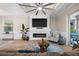 Inviting living room featuring a modern fireplace, TV, and seamless access to the kitchen and dining area at 17459 Palmetto Pass Ln, Punta Gorda, FL 33982
