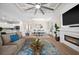 Cozy living room featuring a modern fireplace, stylish decor, and seamless access to the kitchen and dining area at 17459 Palmetto Pass Ln, Punta Gorda, FL 33982