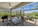 Expansive screened-in patio with outdoor dining, grilling station, and relaxing seating with scenic pond views at 17459 Palmetto Pass Ln, Punta Gorda, FL 33982