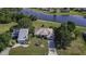 Aerial view of a waterfront home in a neighborhood surrounded by lush greenery and scenic waterways at 1856 Nuremberg Blvd, Punta Gorda, FL 33983