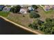 Aerial view of a home with a tile roof, expansive backyard, and waterfront access at 1856 Nuremberg Blvd, Punta Gorda, FL 33983