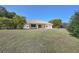 Spacious backyard with lush greenery and a lovely view of the surrounding trees at 1856 Nuremberg Blvd, Punta Gorda, FL 33983