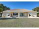 The back of the house features a tile roof, covered porch, with a large backyard at 1856 Nuremberg Blvd, Punta Gorda, FL 33983