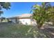 Backyard features landscaping and lots of space. Back of house also has a tiled roof and porch at 1856 Nuremberg Blvd, Punta Gorda, FL 33983