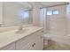 Bright bathroom with a large mirror, white vanity, and bathtub with shower at 1856 Nuremberg Blvd, Punta Gorda, FL 33983