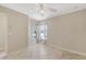 Bright bedroom with neutral walls, tile floors, ceiling fan, and natural light from the windows at 1856 Nuremberg Blvd, Punta Gorda, FL 33983
