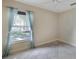 Bright bedroom with a neutral color palette, tile floors, ceiling fan, and a window view at 1856 Nuremberg Blvd, Punta Gorda, FL 33983