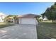 Well-maintained home featuring a clay tile roof, two car garage and manicured landscaping at 1856 Nuremberg Blvd, Punta Gorda, FL 33983