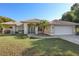Charming single-story home with a tile roof, lush landscaping, and an attached two-car garage at 1856 Nuremberg Blvd, Punta Gorda, FL 33983