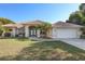 Charming home featuring a clay tile roof, well-manicured lawn, and an attached two-car garage at 1856 Nuremberg Blvd, Punta Gorda, FL 33983