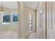 Hallway with tile flooring leading to the dining room, bathroom and outdoor access at 1856 Nuremberg Blvd, Punta Gorda, FL 33983