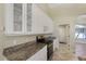Bright kitchen features granite counters, white cabinetry, and stainless steel stove at 1856 Nuremberg Blvd, Punta Gorda, FL 33983