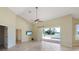 Living room with tile floor and slider to the pool deck with water view at 1856 Nuremberg Blvd, Punta Gorda, FL 33983