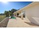 A view of the rear exterior featuring a cozy patio and a small private pool on a sunny day at 1856 Nuremberg Blvd, Punta Gorda, FL 33983