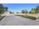 Street view with houses and landscaped lawns under a clear sky at 1856 Nuremberg Blvd, Punta Gorda, FL 33983