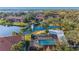 Aerial view showcasing a community pool, serene lake and fountain surrounded by lush landscaping at 19505 Quesada Ave # Ii201, Port Charlotte, FL 33948