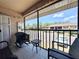 Relaxing screened balcony view with comfortable seating area and scenic view of the parking area at 19505 Quesada Ave # Ii201, Port Charlotte, FL 33948