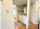Bright bathroom featuring a vanity with modern lighting, complemented by wood-look flooring at 19505 Quesada Ave # Ii201, Port Charlotte, FL 33948