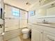 Bright bathroom featuring a shower-tub combo, sleek white vanity, and neutral color palette at 19505 Quesada Ave # Ii201, Port Charlotte, FL 33948