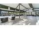 Community clubhouse room features abundant tables, chairs, and bookshelves for activities at 19505 Quesada Ave # Ii201, Port Charlotte, FL 33948