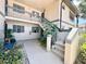 Inviting exterior of condo with well-maintained landscaping and a stairway to the second level at 19505 Quesada Ave # Ii201, Port Charlotte, FL 33948