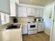 Efficient kitchen with white cabinets, modern appliances, and lots of countertop space at 19505 Quesada Ave # Ii201, Port Charlotte, FL 33948