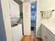 Laundry area with stacked washer/dryer and access to the bathroom at 19505 Quesada Ave # Ii201, Port Charlotte, FL 33948