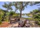 Community wooden benches surrounded by lush landscaping and a scenic lake view with fountain at 19505 Quesada Ave # Ii201, Port Charlotte, FL 33948