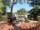 Community wooden benches surrounded by lush landscaping and a scenic lake view with fountain at 19505 Quesada Ave # Ii201, Port Charlotte, FL 33948