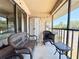 Screened patio with seating area and view of the parking at 19505 Quesada Ave # Ii201, Port Charlotte, FL 33948