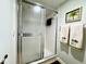 Shower with sliding glass door and palm tree towels at 19505 Quesada Ave # I201, Port Charlotte, FL 33948