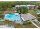 Aerial view showcasing the community pool, pool house, and surrounding greenery, offering a serene retreat at 1999 Kings Hwy # 24C, Punta Gorda, FL 33980