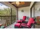Relaxing balcony featuring comfortable seating, ceiling fan and scenic tree view at 1999 Kings Hwy # 24C, Punta Gorda, FL 33980