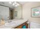 Bathroom with a sink and white countertop, with shower and flamingo art at 1999 Kings Hwy # 24C, Punta Gorda, FL 33980