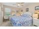 Bright bedroom with a queen bed, dresser, and sunny windows with a nautical theme at 1999 Kings Hwy # 24C, Punta Gorda, FL 33980