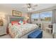 Bedroom with ceiling fan, a comfortable queen bed, and natural light from large windows at 1999 Kings Hwy # 24C, Punta Gorda, FL 33980
