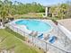 Beautiful aerial shot of the community pool with lounge chairs and nearby tennis courts at 1999 Kings Hwy # 24C, Punta Gorda, FL 33980