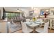 Open-concept living space featuring updated lighting, comfortable furniture, and a screened lanai at 1999 Kings Hwy # 24C, Punta Gorda, FL 33980