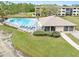 Aerial shot of the community pool, surrounded by lush landscaping and lounge chairs, perfect for relaxation at 1999 Kings Hwy # 24C, Punta Gorda, FL 33980